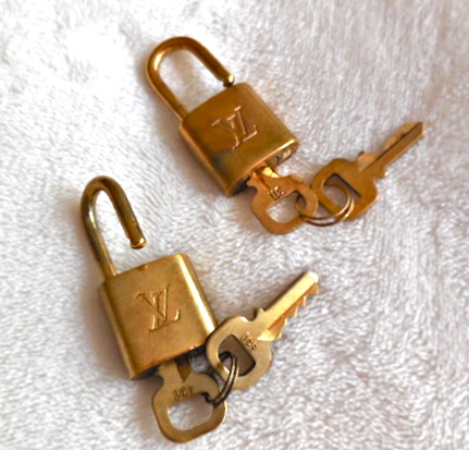 Lot 999 - Two Louis Vuitton lock and keys.
